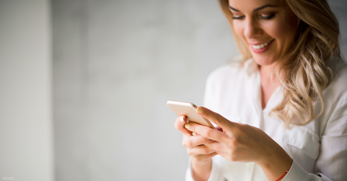 Woman looking at phone and smiling